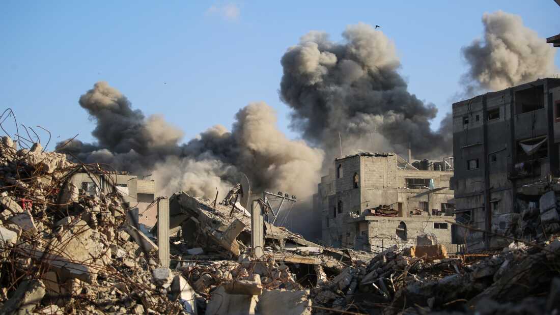 Smoke billows following an Israeli strike that targeted a building in the Bureij camp for Palestinian refugees in the central Gaza Strip on Oct. 19.