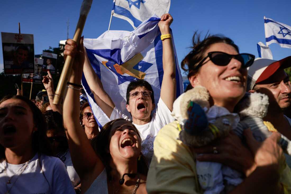 Israelis react as they wait for the release of Israelis still held in Gaza at Hostages Square in Tel Aviv early on Oct. 13, 2025.