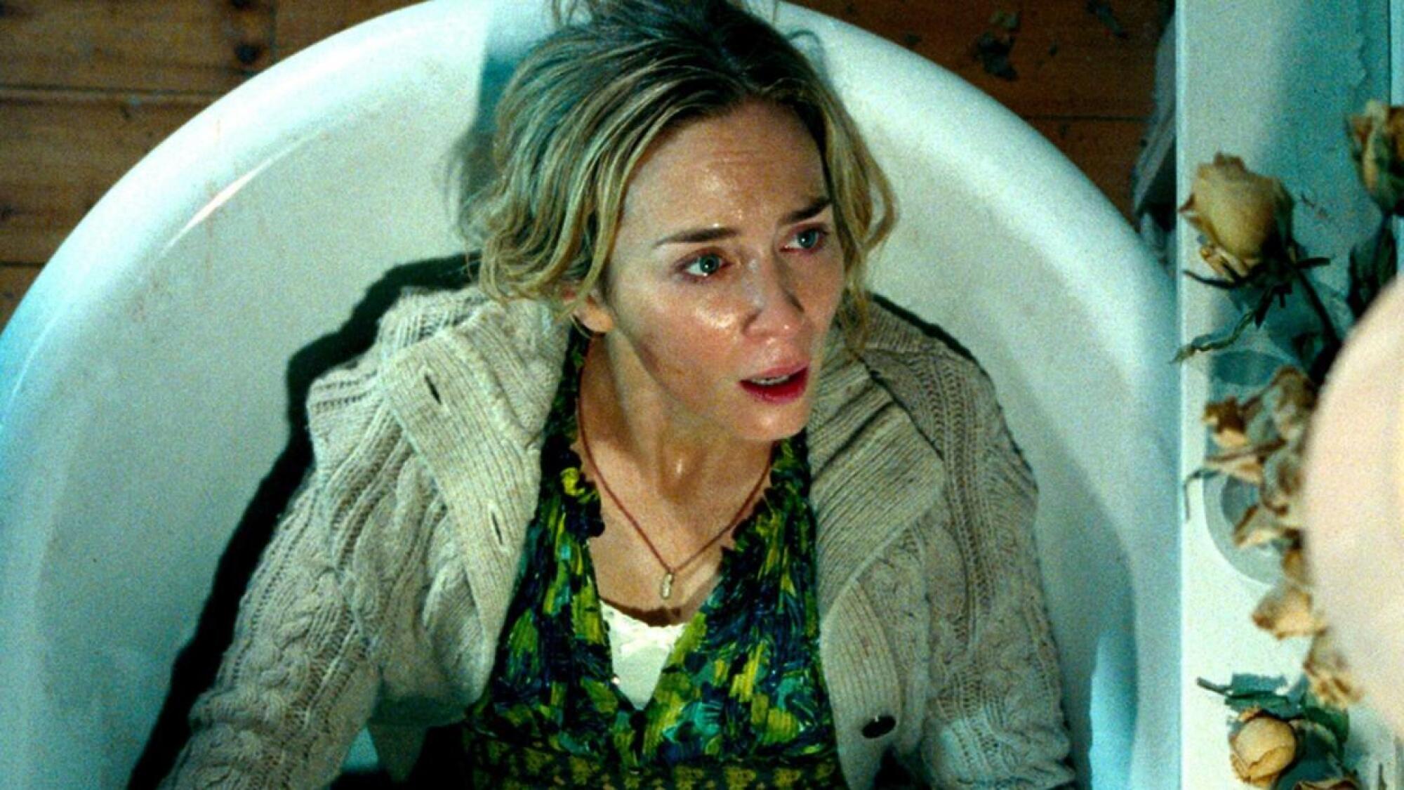 Emily Blunt hides in a bathtub in