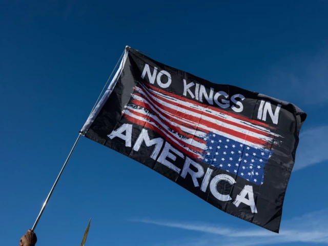 a demonstrator waves a flag during a rally at the lincoln memorial in washington dc us oct 17 2025 photo afp