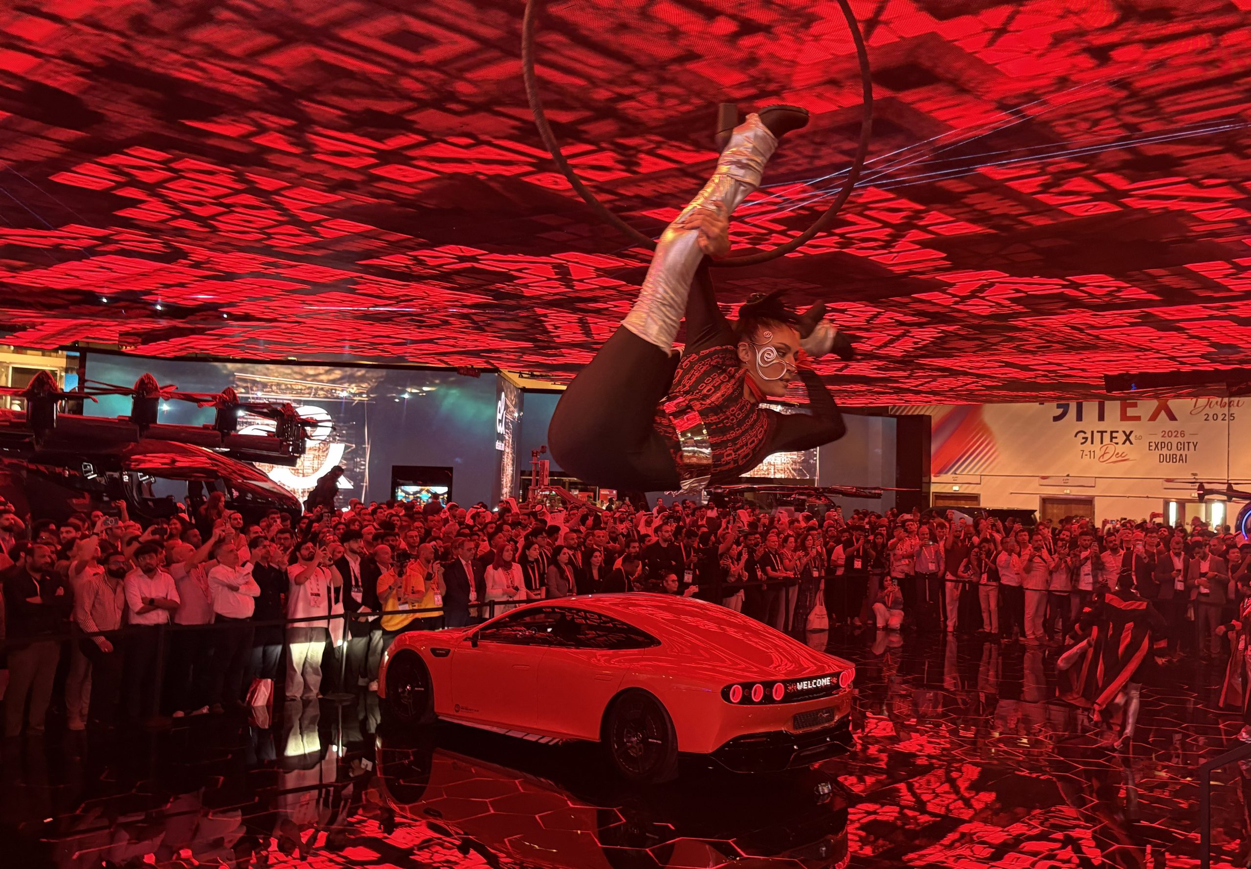 An image of a dancer above a car at GITEX