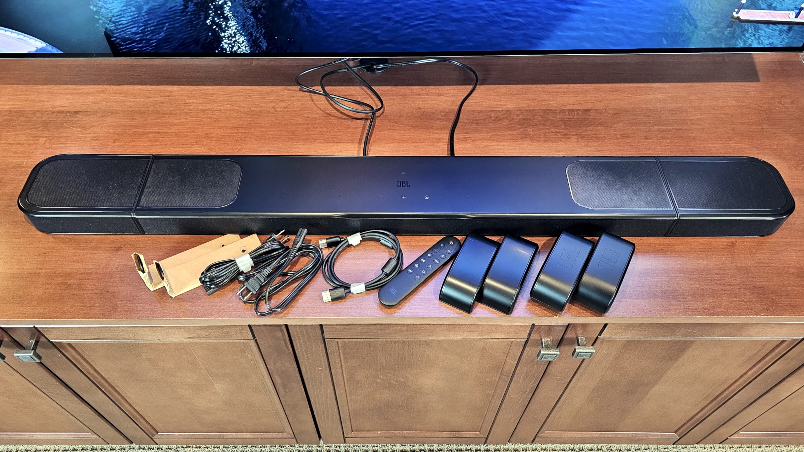 JBL Bar 1000MK2 on TV stand with accessories