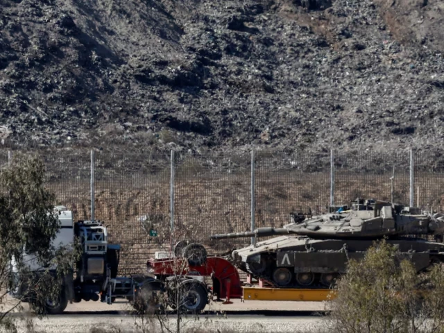 a truck transports a tank on the israeli side of the border with gaza in israel october 19 2025 photo reuters