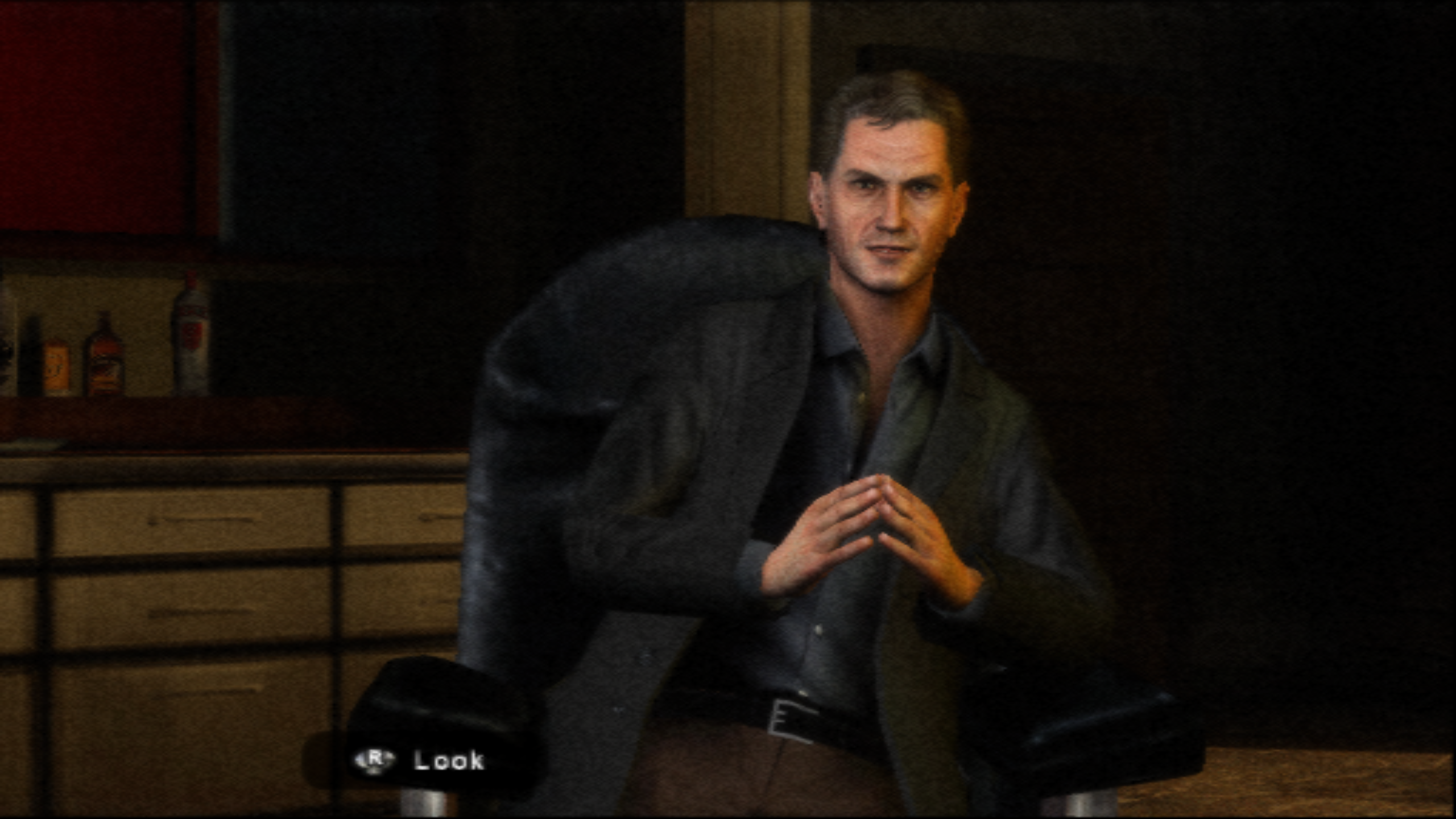 Screenshot of Silent Hill: Shattered Memories (man sitting on chair with fingertips touching each other)